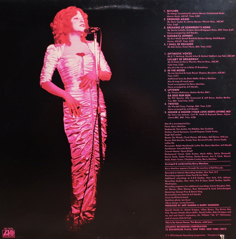 May include: A woman with red hair sings into a microphone. The album cover features the song titles "Skylark", "Drinking Again", "Breaking Up Somebody's Home", "Surabaya Johnny", "I Shall Be Released", "Optimistic Voices", "Lullaby of Broadway", "In the Mood", "Da Doo Run Run", "Twisted", "Higher & Higher (Your Love Keeps Lifting Me)".