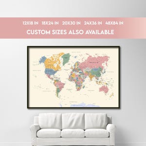 May include: A framed world map print featuring countries, cities, seas, rivers, deserts, and mountains in muted colors on a cream background. Text includes: HIGHLY DETAILED: COUNTRIES, CITIES, SEAS, RIVERS, DESERTS, MOUNTAINS, 12X18 IN 18X24 IN 20X30 IN 24X36 IN 48X84 IN, CUSTOM SIZES ALSO AVAILABLE, INSTANT DIGITAL DOWNLOAD.