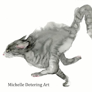 May include: A watercolor painting of a grey cat in a dynamic running pose, captured in motion with fluid brushstrokes and varying shades of grey. The artwork features the text Michelle Detering Art at the bottom left corner against a white background.