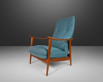 May include: A blue upholstered armchair with wooden arms and legs. The chair has a high back and a tufted seat.