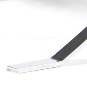May include: Close-up of a silver metal chair leg with a black rubber foot pad.