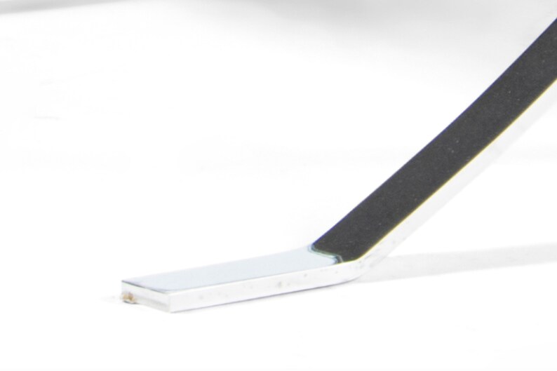 May include: Close-up of a silver metal chair leg with a black rubber foot pad.