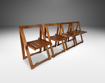 May include: Four wooden folding chairs in a row. The chairs are made of dark brown wood and have a simple, minimalist design.