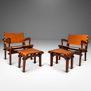 May include: Two brown leather chairs with matching brown leather ottomans. The chairs and ottomans have a woven leather design.