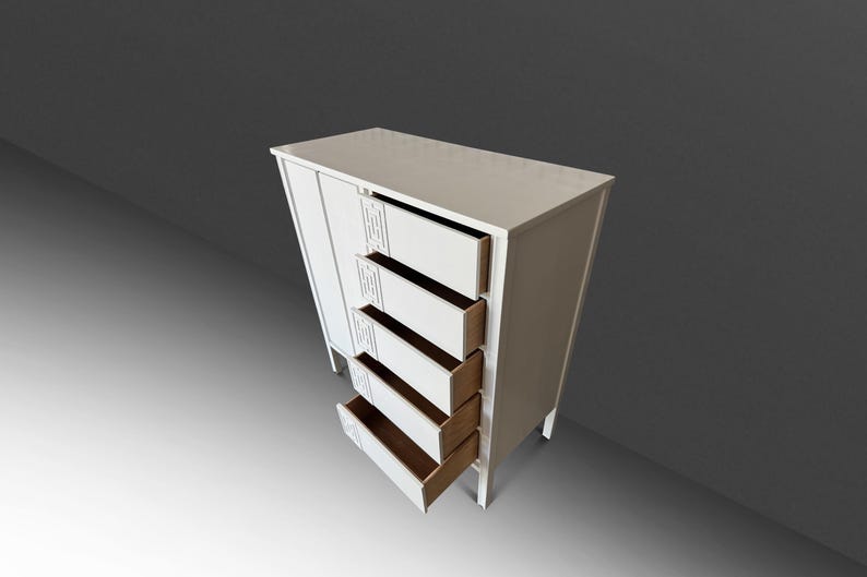 May include: A white wooden cabinet with four open drawers and a closed door. The cabinet has a rectangular shape and is elevated on short legs. The drawers are open, revealing a light brown interior. Decorative cutouts are on the cabinet's front.