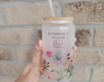 May include: A frosted glass tumbler with a bamboo lid and a straw. The tumbler has a floral design and the text "Her children rise up and call her blessed, Proverbs 31:28".