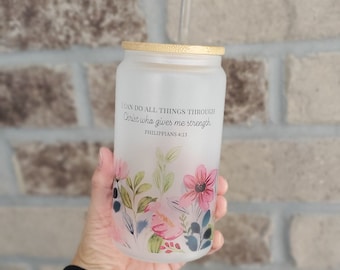 May include: A white frosted glass tumbler with a bamboo lid and a straw. The tumbler has a floral design and the text "I can do all things through Christ who gives me strength. Philippians 4:13"