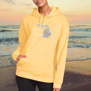 May include: A yellow hoodie with a white outline of the state of Michigan and the text "Michigan Rocks" on the front.