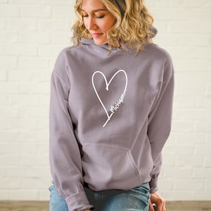May include: A lavender colored hoodie with a white heart and the word "Michigan" written inside the heart.