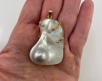 14K blister pearl and diamond pendant, unique shape and design set in a yellow gold frame