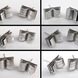 May include: A pair of silver book-shaped earrings with different engraved text on each side. The text includes quotes and personal messages.
