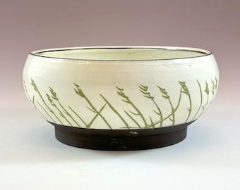 White big bowl handmade decorated with green grass.