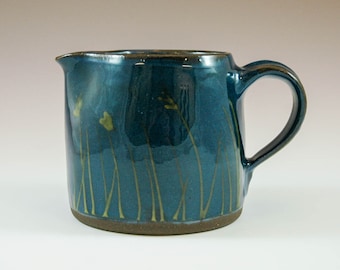 Blue pitcher with grass decorations for the nature lovers.