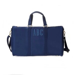 a blue duffel bag with the initials abc on it