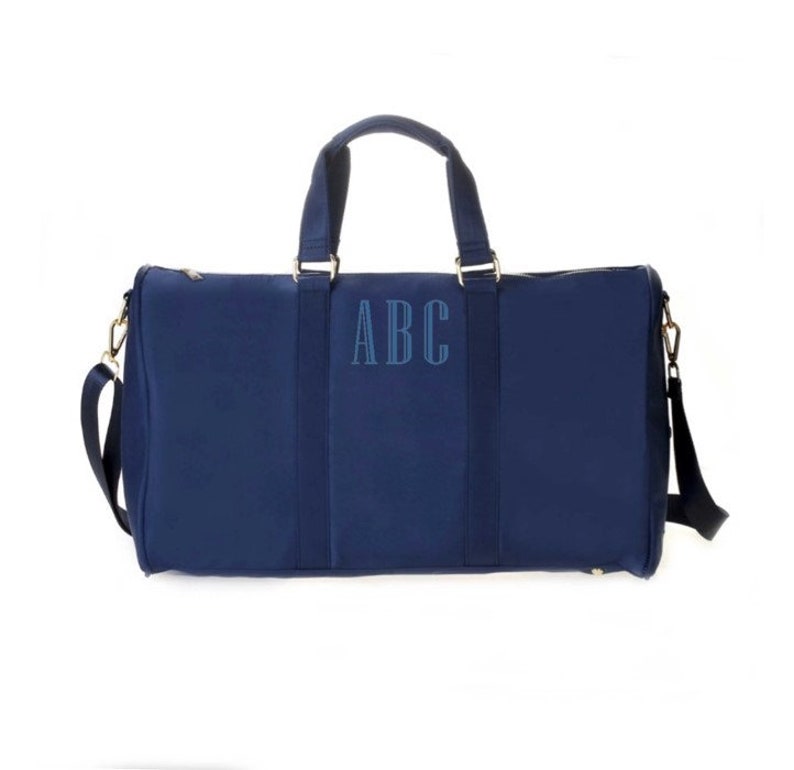 a blue duffel bag with the initials abc on it