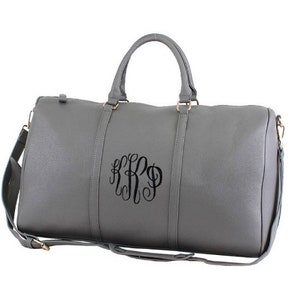 a gray duffel bag with a font option #6 monogram