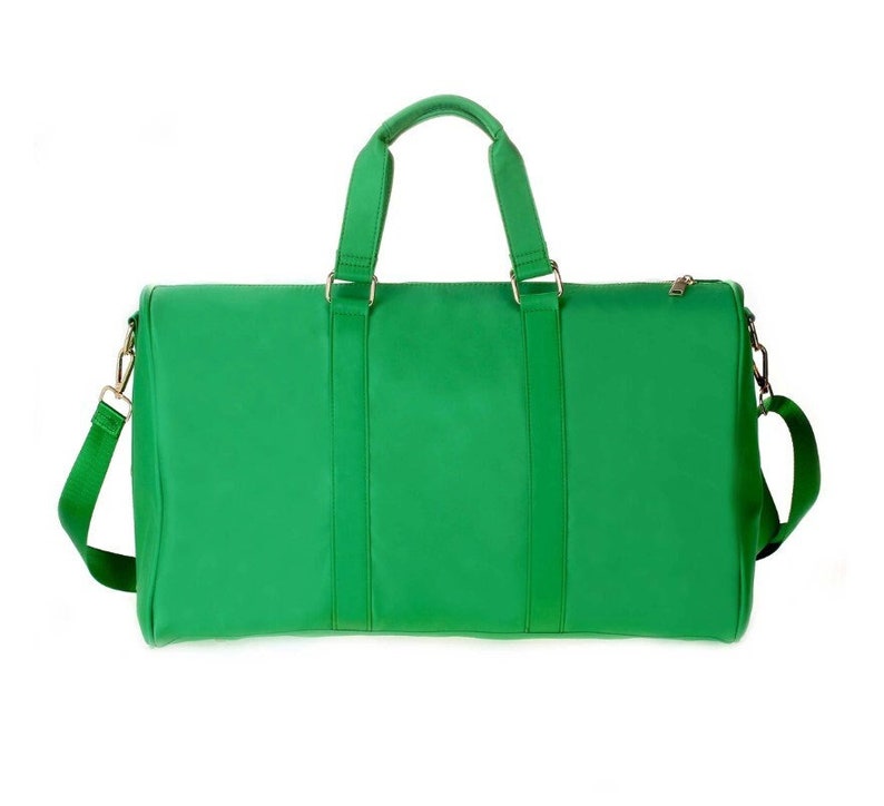 a green bag with a handle on a white background