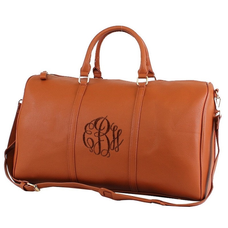 a brown leather duffel bag with a  font option #6 monogram