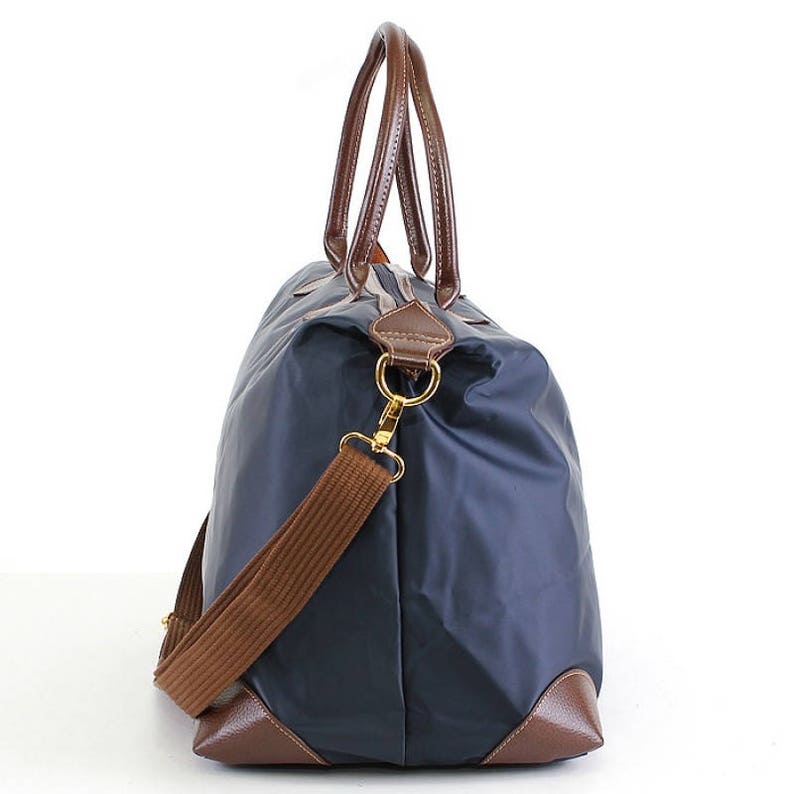 a blue and brown bag with a brown strap