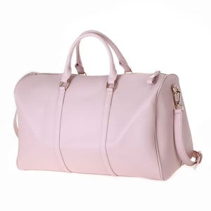 a pink leather duffel bag on a white background