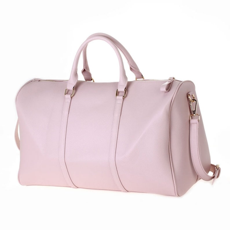 a pink leather duffel bag on a white background