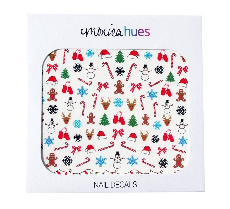 May include: A sheet of white nail decals with a Christmas theme. The decals feature a variety of festive designs, including snowmen, reindeer, candy canes, gingerbread men, snowflakes, bows, and Christmas trees. The decals are perfect for adding a touch of holiday cheer to your nails.