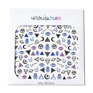 May include: A sheet of nail decals with a white background and a repeating pattern of black, blue, and purple geometric shapes, including triangles, eyes, moons, and stars. The text "monicahues" and "NAIL DECALS" are printed on the sheet.