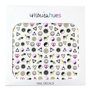 May include: A white sheet of nail decals with a repeating pattern of black and white symbols including peace signs, yin yangs, hearts, stars, smiley faces, daisies, and unicorns. The text "monica hues" and "NAIL DECALS" are printed on the packaging.