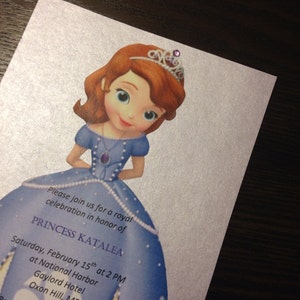 May include: A purple and blue princess-themed invitation with a cartoon image of Princess Sofia. The invitation reads "Please join us for a royal celebration in honor of Princess KataleA. Saturday, February 15th at 2 PM at National Harbor Gaylord Hotel Oxon Hill, MD. Regrets only 301.452.5353"