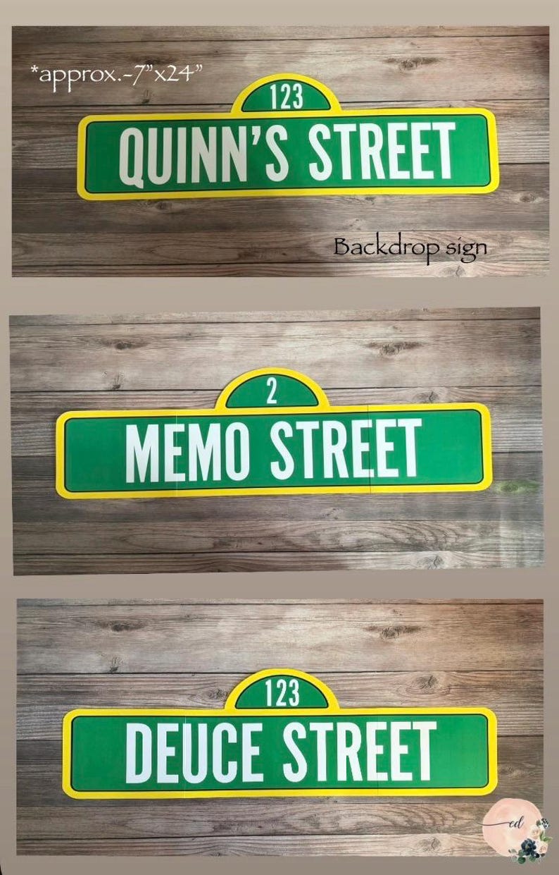 May include: Three street signs with a green and yellow design. The top sign reads "QUINN'S STREET" with the number "123". The middle sign reads "MEMO STREET" with the number "2". The bottom sign reads "DEUCE STREET" with the number "123".