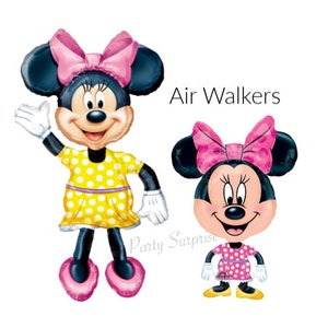 May include: Two Minnie Mouse air walker balloons. One is a full-body balloon with a yellow polka dot dress and pink bow. The other is a smaller balloon of Minnie's face and torso, wearing a pink polka dot dress and bow. Text reads "Air Walkers".
