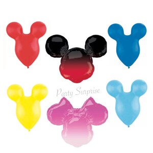 May include: A collection of colorful, Mickey Mouse-shaped balloons in red, black, blue, yellow, pink, and light blue. The balloons are arranged against a white background. The text "Party Surprise" is visible.