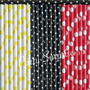 May include: A set of paper straws with polka dots in yellow, black, and red. The straws are arranged in three rows, with each row featuring a different color. The text "Party Surprise" is printed on the straws.