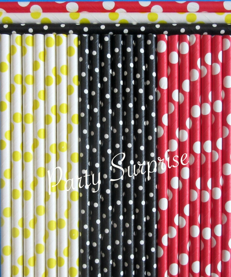 May include: A set of paper straws with polka dots in yellow, black, and red. The straws are arranged in three rows, with each row featuring a different color. The text "Party Surprise" is printed on the straws.