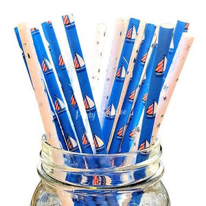 May include: A bundle of blue and white striped paper straws with red sailboats printed on them. The straws are in a clear glass jar.