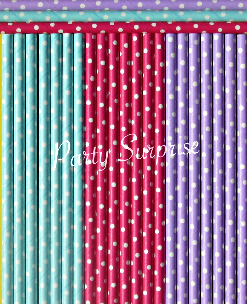 May include: A set of colorful paper straws with white polka dots. The straws are arranged in rows of blue, pink, and purple. The text "Party Surprise" is printed on the straws.