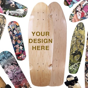 May include: A blank, light-coloured wooden skateboard deck positioned centrally, featuring the text "YOUR DESIGN HERE" in brown. It is surrounded by various other skateboard decks decorated with colourful, detailed cartoon character illustrations.
