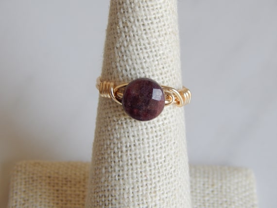 Faceted garnet ring, gold wire wrapped