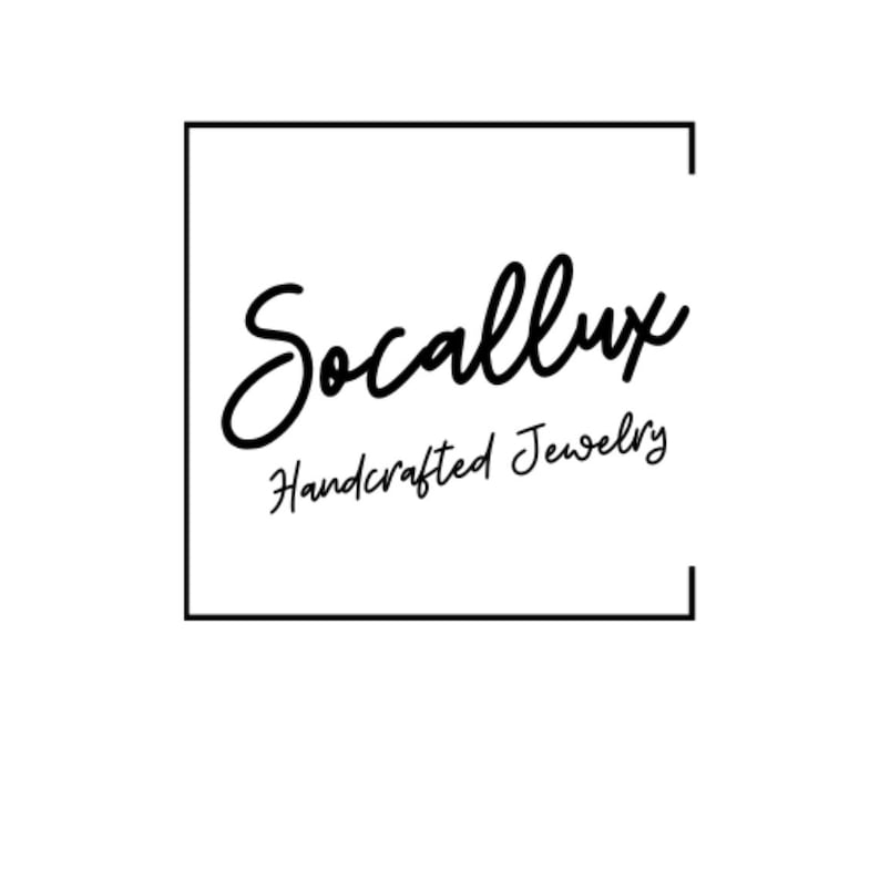 May include: Black and white logo for Socallux Handcrafted Jewelry. The brand name is written in a cursive font inside a black square. Below the brand name, the words "Handcrafted Jewelry" are written in a smaller, more casual font.