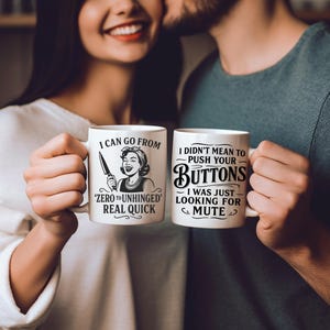 May include: Two white ceramic mugs with black text and illustrations. The mug on the left says "I can go from 'zero to unhinged' real quick" and features a woman with a knife. The mug on the right says "I didn't mean to push your buttons - I was just looking for mute".