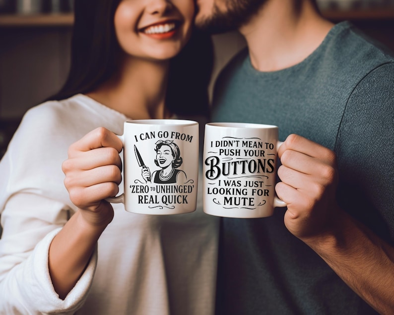 May include: Two white ceramic mugs with black text and illustrations. The mug on the left says "I can go from 'zero to unhinged' real quick" and features a woman with a knife. The mug on the right says "I didn't mean to push your buttons - I was just looking for mute".