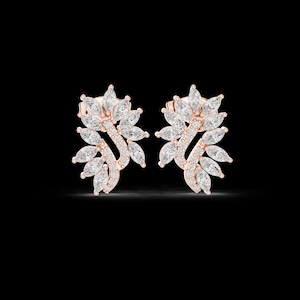May include: A pair of rose gold stud earrings featuring a curved, leaf-like design. Each earring is encrusted with multiple marquise-cut clear stones arranged in a fan pattern, accented by a row of small round stones along the central curved stem.