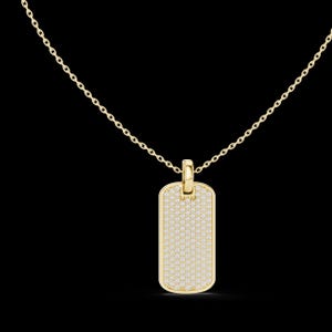 Peut inclure: Un collier pendentif en forme de plaque d'identité de couleur or. Le pendentif rectangulaire est recouvert de petites pierres scintillantes. La chaîne du collier est également dorée et délicate. Le fond est noir.