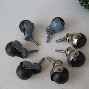 May include: Eight black swivel casters with metal stems. The casters have a silver, gray, and gold finish.