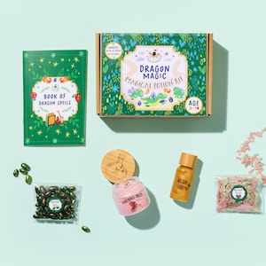 May include: A children's Dragon Magic Magical Potion Kit with a green book of dragon spells, a box, and various potion ingredients. The kit includes a jar of Fireball Dust and a bottle of Ancient Gold.