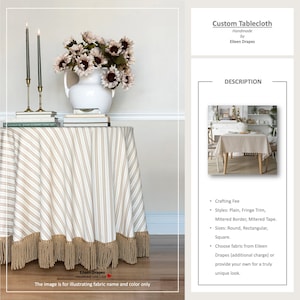 Könnte beinhalten: Ein runder Tischläufer mit beigem und weißem Streifenmuster und Fransenbesatz. Der Tisch ist mit einer weißen Vase mit Blumen, Kerzen und Büchern gedeckt. Der Text "Custom Tablecloth Handmade by Eileen Drapes" ist sichtbar.