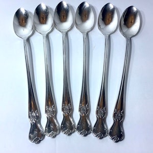 May include: Set of six silver teaspoons with ornate handles. Each handle features a floral design and an engraved letter 'S'.