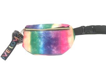 May include: A rainbow tie-dye fanny pack with a black adjustable strap and a black strap with the words "I've Love" in rainbow colors.