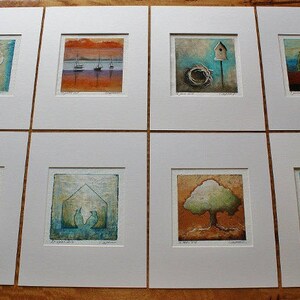 May include: Eight framed art prints with a nature theme. Each print features a different image, including birds, trees, and houses. The prints are all in a white frame with a white mat.