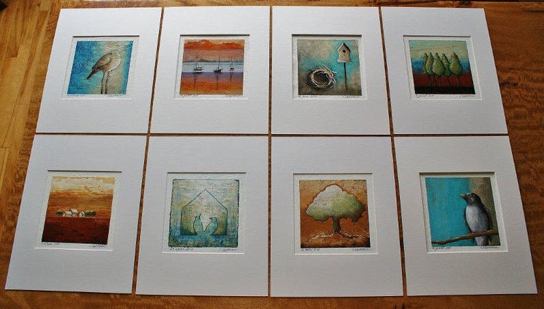 May include: Eight framed art prints with a nature theme. Each print features a different image, including birds, trees, and houses. The prints are all in a white frame with a white mat.